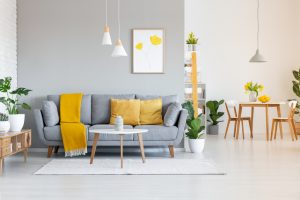 Orange,Blanket,On,Grey,Sofa,In,Modern,Apartment,Interior,With